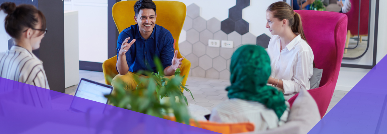 Four people sit in colorful chairs, engaged in a lively discussion about channel maturity in a modern office with geometric wall decor. One man gestures enthusiastically while others listen and smile, with laptops and plants visible in the scene.